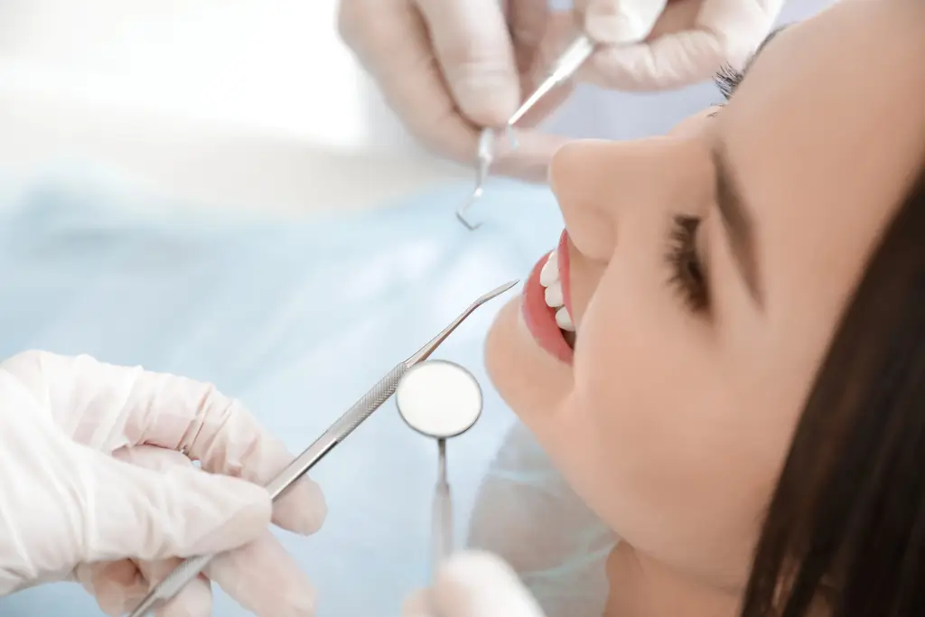 arafed woman getting her teeth examined by a dentist