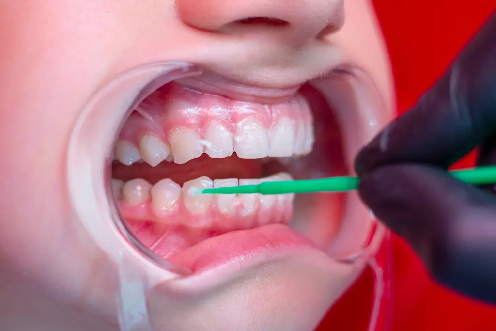 a close up of a child ' s mouth with a toothbrush in it
